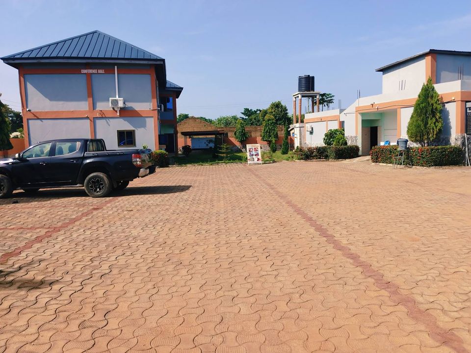 Guest buildings and a parked pickup around the paved compound